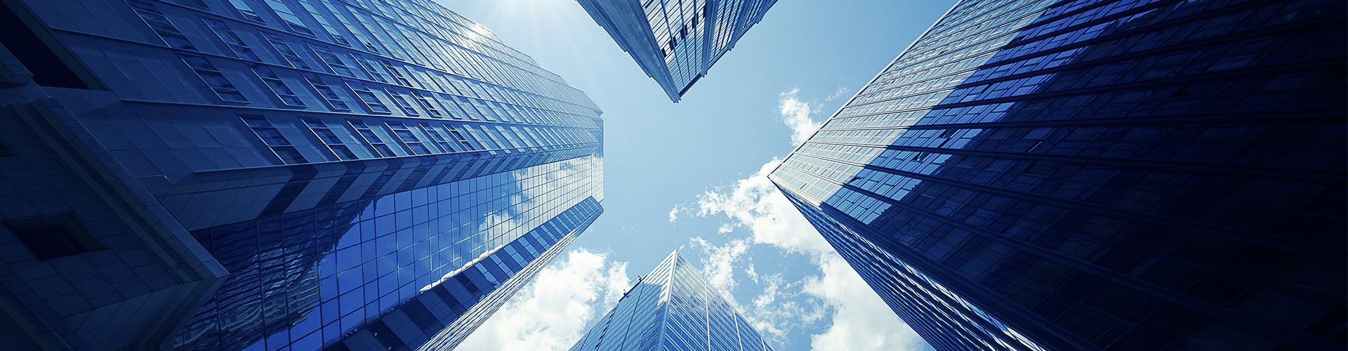 Looking up at four office buildings