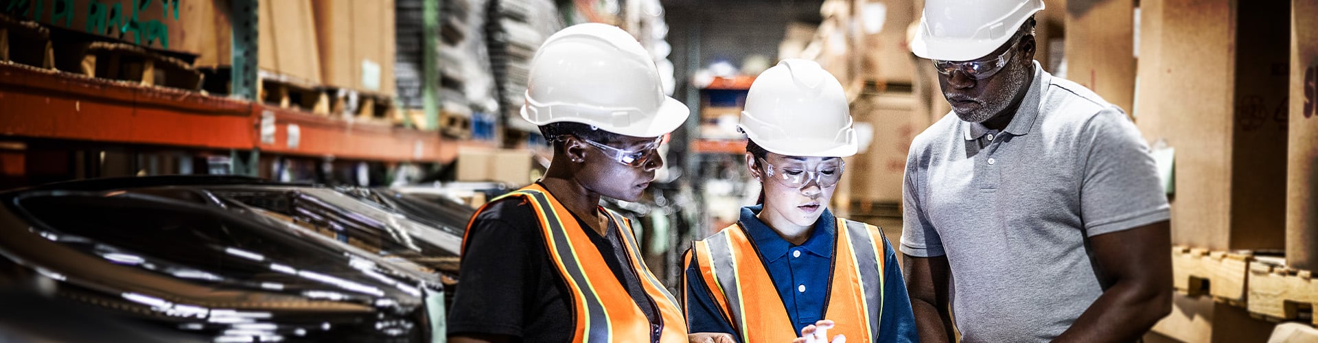 Warehouse workers looking at tablet