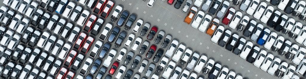 Bird's eye view of rows of cars in a car park